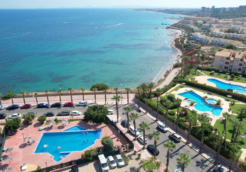 Aerial view of Orihuela Costa coastline with beach and pools, Costa Blanca South