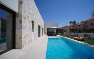 Long private pool beside the villa's stone façade
